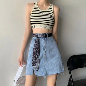 Women's denim skirt with paisley scarf belt and striped crop top in casual style