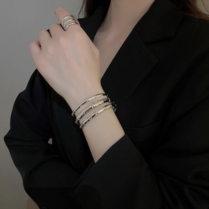 Close-up of silver-plated bamboo-textured triple layer open cuff bracelet and matching ring
