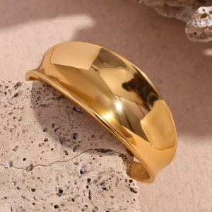 Macro view of wide 18K gold plated ring with smooth concave polished surface on stone