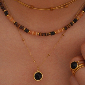Gold-plated stainless steel necklace and black onyx ring set worn by model