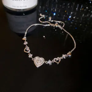 Adjustable hollow heart bracelet with shimmering zircons and shell heart pendant