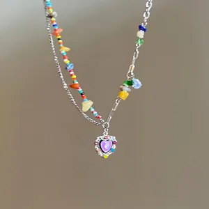 Rainbow beaded necklace with purple heart pendant and colorful gemstone accents