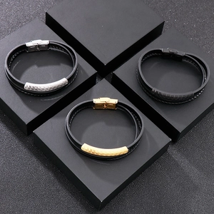 Detail view of woven leather bracelets with silver, gold, and black stainless steel clasps