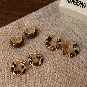 Three pairs of vintage ethnic style tiger eye beaded hoops and brown enamel earrings