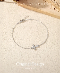 Detail of 925 sterling silver cross bracelet with sparkling stones and adjustable clasp