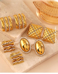 Detailed view of vintage gold plated stainless steel stud earrings with white zircons
