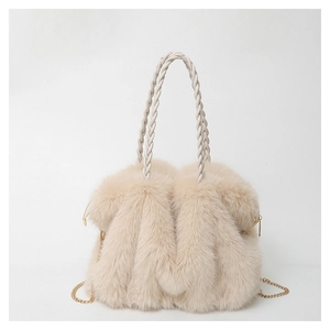 Close-up of plush beige faux fur tote bag with woven handle and gold metal chain strap