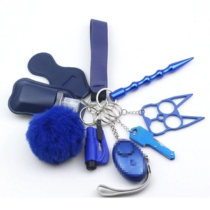 Detailed blue self-defense keychain set including alarm, wristband, and fluff ball charm