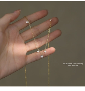 Detailed view of S925 sterling silver gold necklace featuring five sparkling zircon stones