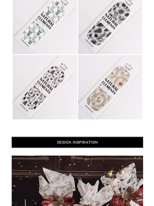 Detailed view of Christmas tissue paper featuring reindeer and winter cabin patterns