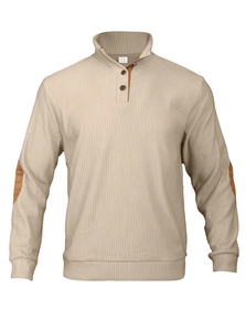 Detailed close-up of beige ribbed knit sweater featuring brown elbow patches and stand collar