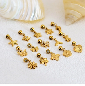 Golden stainless steel charms in star, heart, and clover shapes on a white background