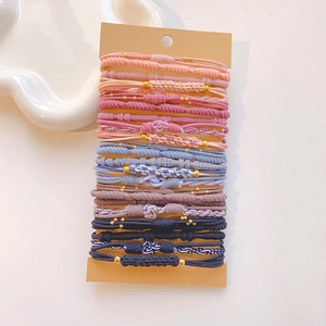 Detail of multi-style gradient hair ties set with gold bead accents on card