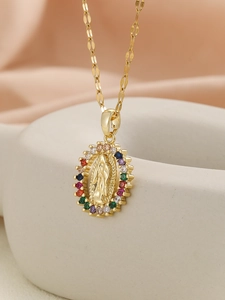Macro detail of 18K gold Virgin Mary pendant with colorful cubic zirconia border