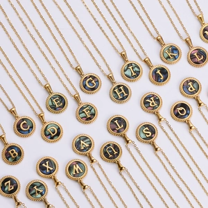 Collection of gold round pendants featuring shell inlay and A-Z alphabet engravings