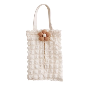 Close-up of cream white bubble texture tissue box bag with a brown corduroy flower