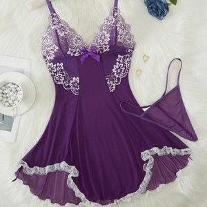 Dark purple lace lingerie set with V-neck chemise and thong on white faux fur background