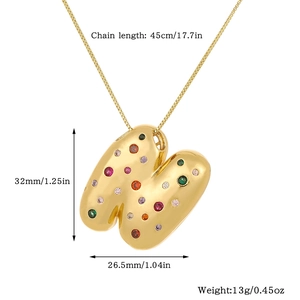 Detail view of gold letter H pendant with dimensions 32mm by 26.5mm and 45cm chain