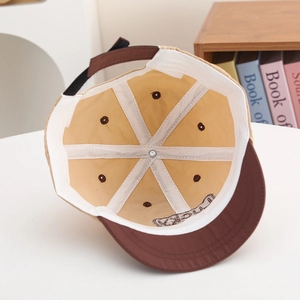 Internal view of a kids' baseball cap showing the Lucky embroidery and reinforced seams
