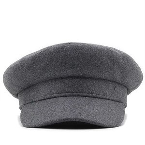 Detailed close-up of a dark grey wool flat top cadet cap showing thick fabric texture