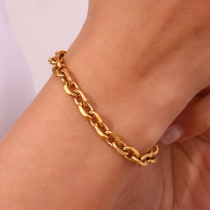 Detail view of 18K gold plated stainless steel chain bracelet on a wrist