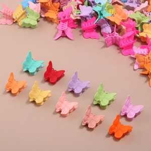 Macro shot of colorful matte butterfly hair clips in various pastel macaron colors