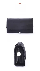 Detail view of foldable black nylon makeup brush bag with silver zipper and buckle