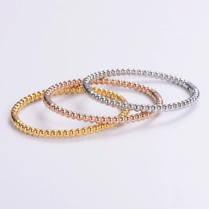 Three-piece stainless steel beaded bangle set in gold, rose gold and silver finishes