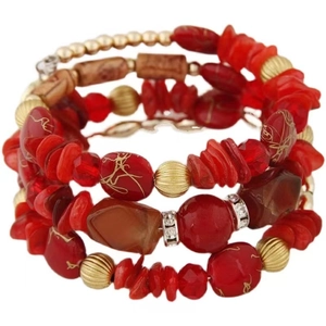 Detail of red multilayer beaded bracelet with turquoise stones and gold metal spacers