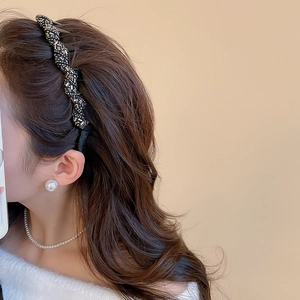 Detail of twisted black rhinestone headband with sparkling sequins for an elegant look