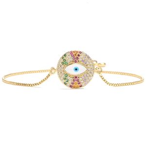 Adjustable 18k gold plated evil eye bracelet with colorful zirconia inlays on white background
