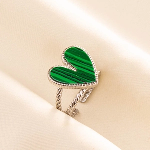 Detailed macro of a silver twisted ring featuring a heart-shaped green malachite stone