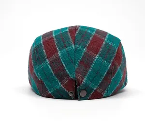 Detail view of colorful plaid ivy cap back with adjustable metal buckle and wool texture