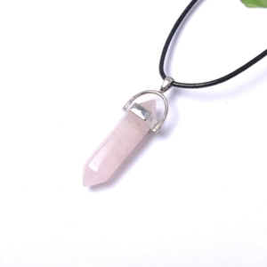 Detail of rose quartz hexagonal pendant with silver clasp and black cord necklace