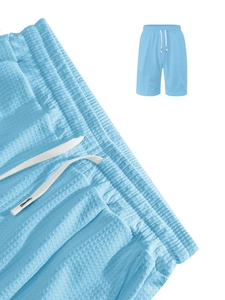 Macro shot of sky blue waffle fabric texture and white drawstring on casual shorts
