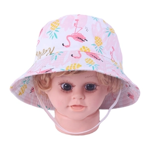 Detail of baby sun hat with flamingo and pineapple prints and adjustable white chin strap