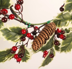 Detailed view of Christmas wreath featuring red berries, pine cones and holly leaves