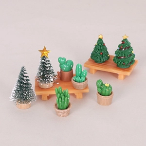 Miniature Christmas trees and cactus figurines on wooden stools for DIY desk decor