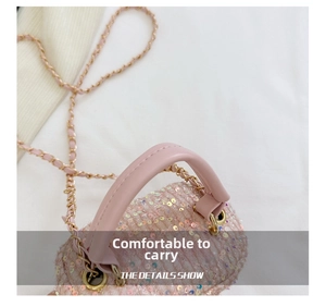 Detail of pink iridescent sequin handbag featuring a comfy leather handle and gold chain