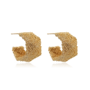 Unique geometric C-shaped golden earrings with textured lava finish on white background