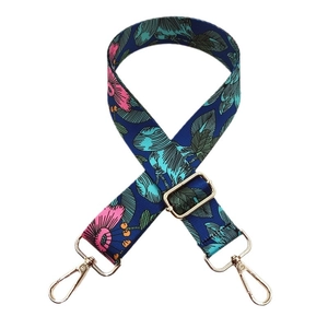 Adjustable blue floral fabric bag strap with pink flowers and gold metal hooks