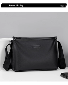 Detail of black lychee-grain leather crossbody bag with metal logo and woven strap