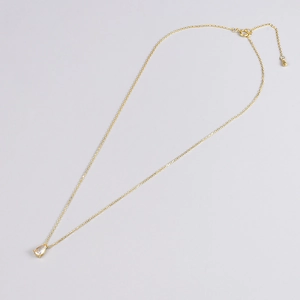 Detailed view of gold chain necklace featuring a teardrop zircon and adjustable metal clasp