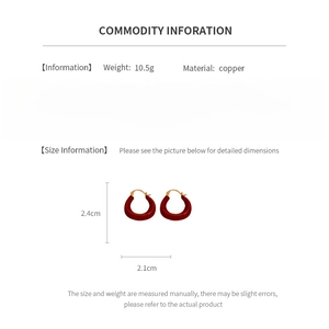 Detail view of red U-shaped earrings with size specs 2.4cm height and 2.1cm width