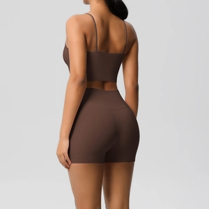 Detail of high-waisted lift shorts and criss-cross back sports bra in dark coffee