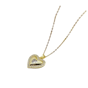 Elegant gold heart pendant necklace with sparkling white zircons on a white background