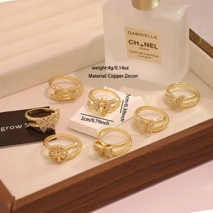 Macro detail of gold plated copper rings with micro-set zircon and bowknot design