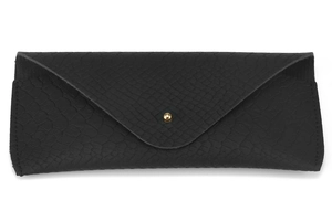 Detail of black faux leather eyewear case with snake texture and gold bead snap closure