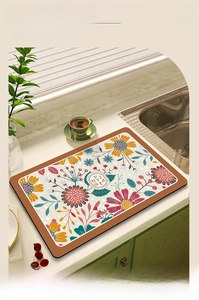 Close-up of floral absorbent dish drying mat on kitchen counter with sunflower patterns