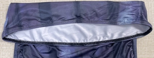 Detail view of purple and black print dress with fine stitching and light gray lining